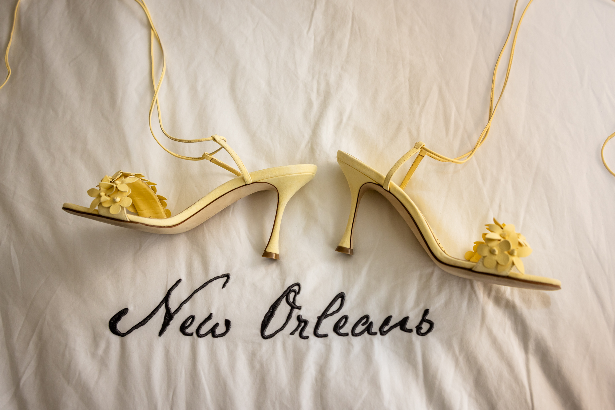 The bride's shoes on the bed of the New Orleans International House Hotel.